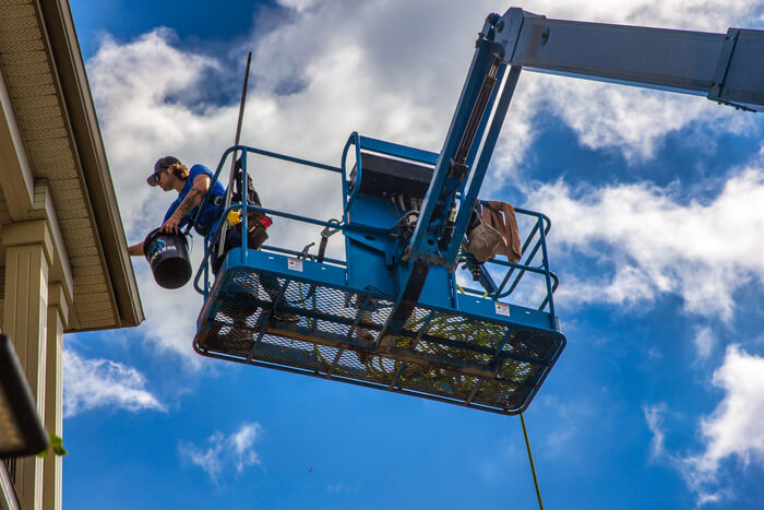 edmonton gutter cleaning pros - commercial eavestrough being cleaned